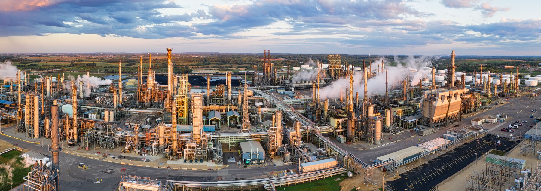 Oil and gas refinery with processing towers, pipelines, and operating facilities